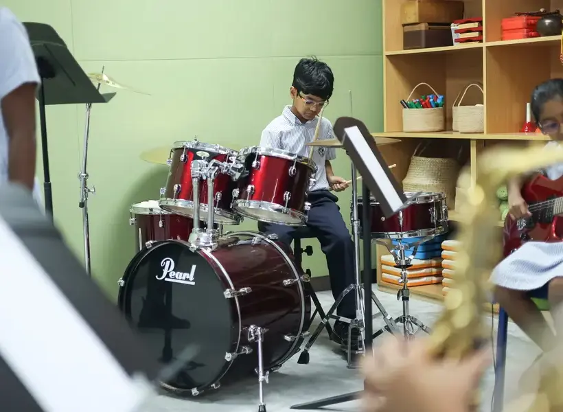 Young student playing the drums.