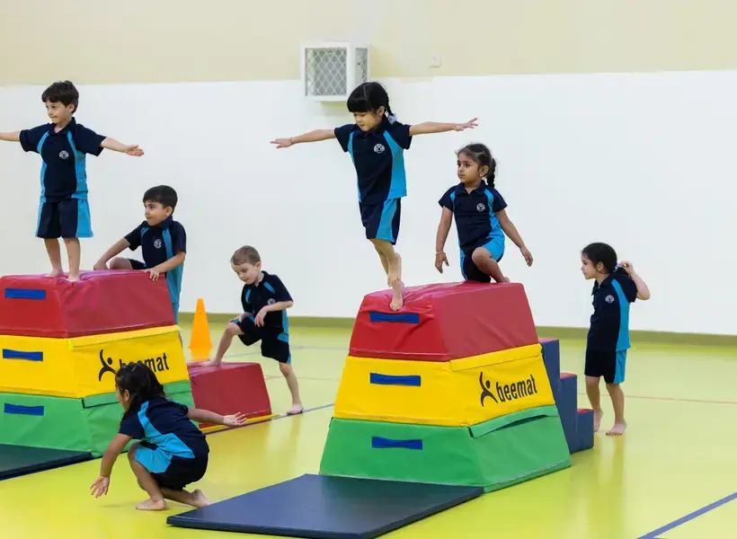 Students balancing on soft blocks.